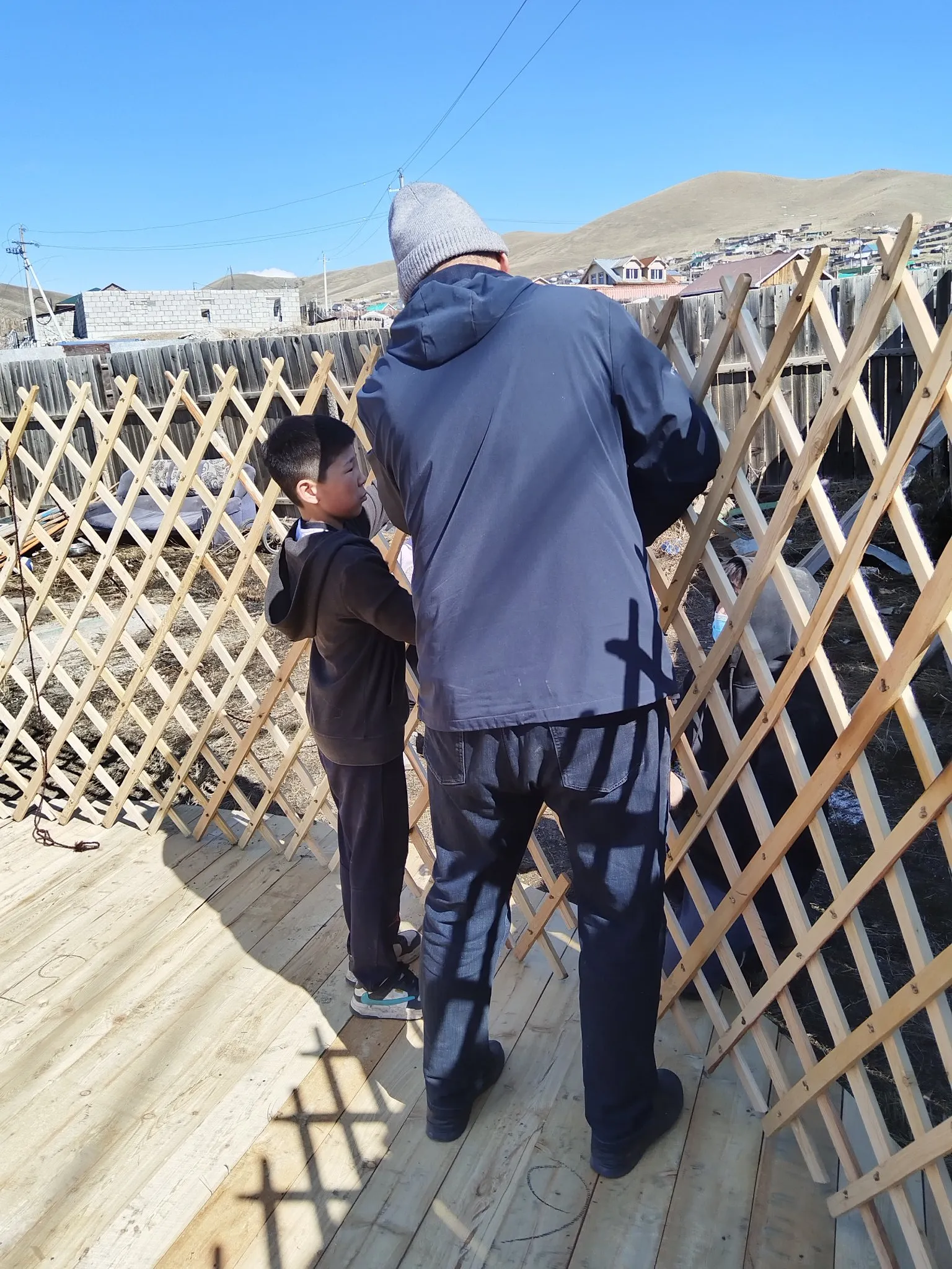 One of the children helps our employee build the tent
