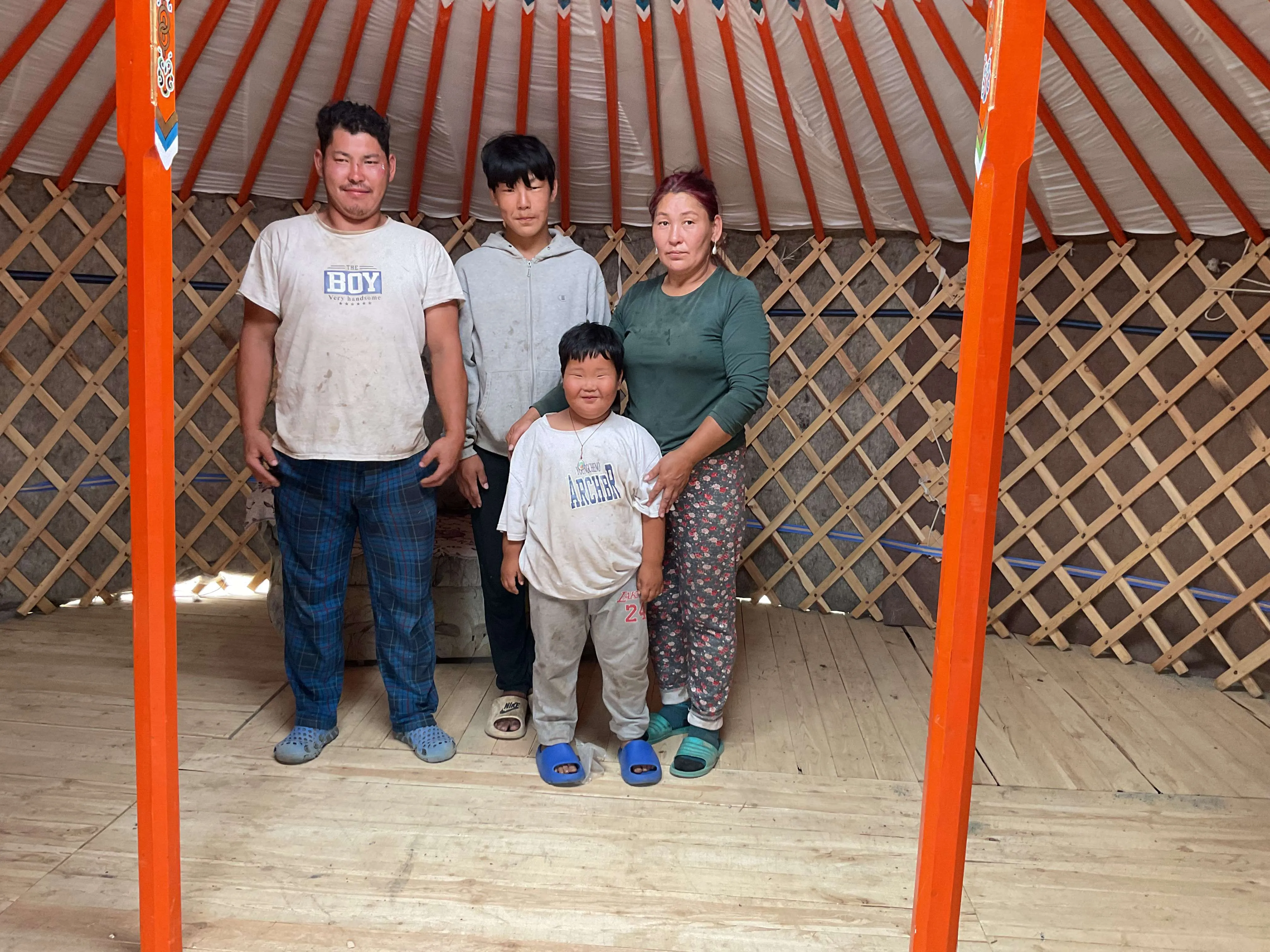 The family in their new tent under construction